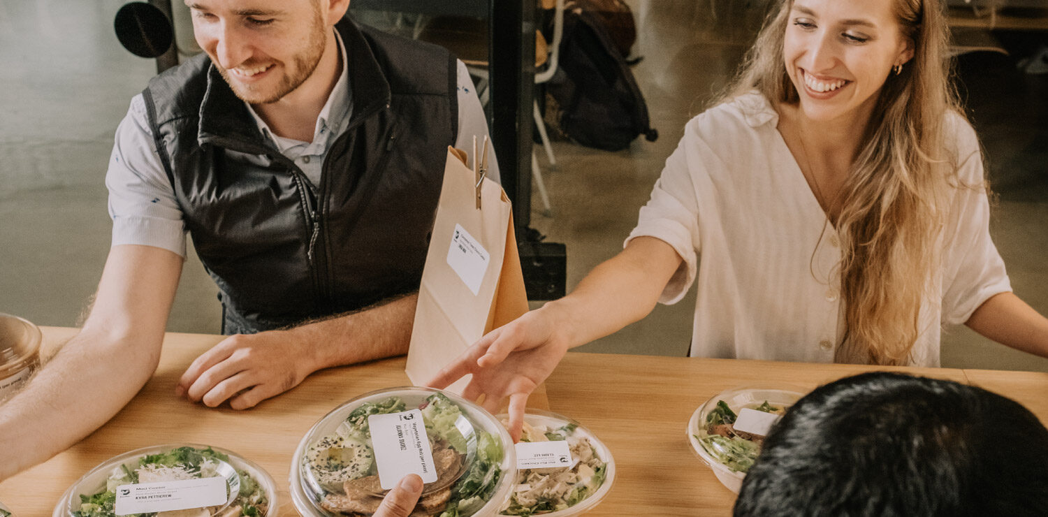 A team of professionals distributing their pre-packaged Foodee meals.